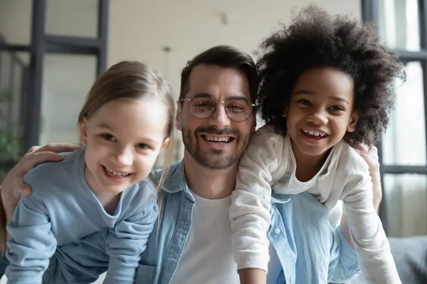 Overjoyed dad playing with multiracial little daughters — Stock Photo, Image
