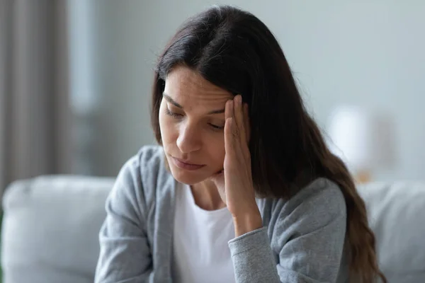 Ongelukkige attente vrouw die haar gezicht aanraakt, denkend aan problemen — Stockfoto