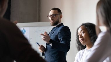 Toplantıda orta yaşlı işadamı erkek beyaz tahta sunumundan bahsetti