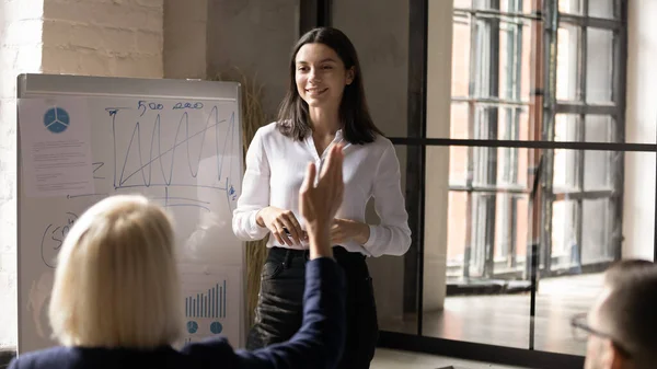 Millennial female coach interact with diverse employees at meeting — Stock Photo, Image