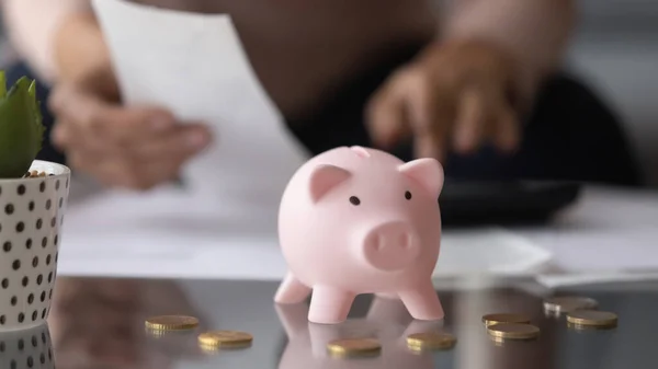 Close up focus on piggybank on table, family savings concept.