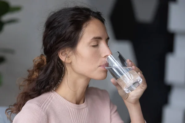 Peaceful calm millennial woman drinking glass of pure distilled aqua. — Stock Photo, Image