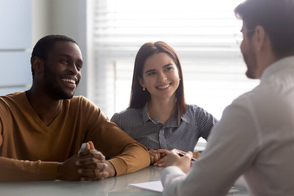 Young successful couple, diverse man and woman listening manager.