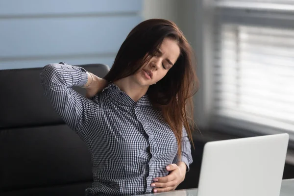 Unhappy businesswoman massaging neck, suffering from pain. — Stock Photo, Image