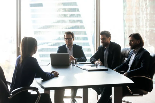 Three confident hr managers holding job interview with candidate