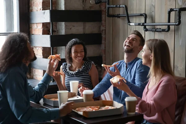 Happy diverse friends have fun eating out together