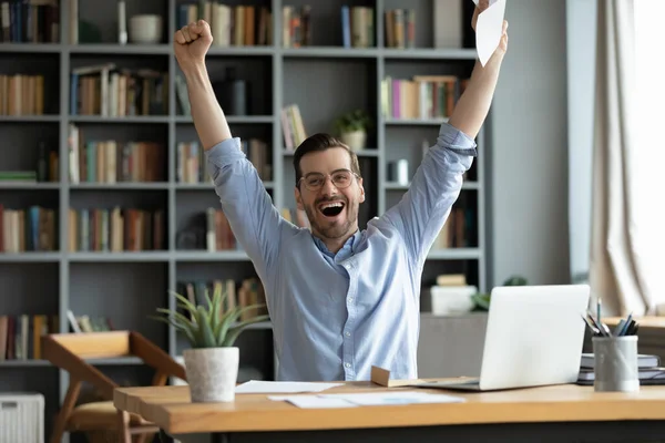 Excited overjoyed man received good news in letter, celebrate success