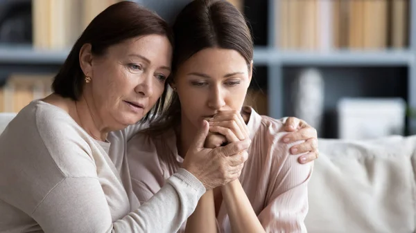 Loving middle aged mother hugging comforting adult daughter — Stock Photo, Image