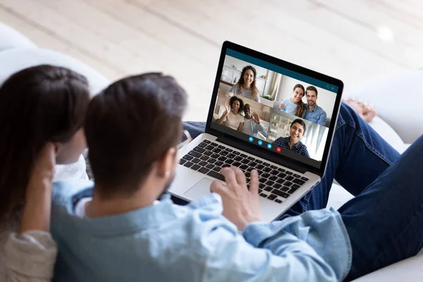 Young couple talk on video call with diverse friends — Stock Photo, Image