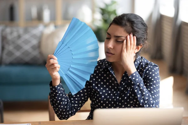 Young exhausted indian woman waving paper fan. — Stock Photo, Image