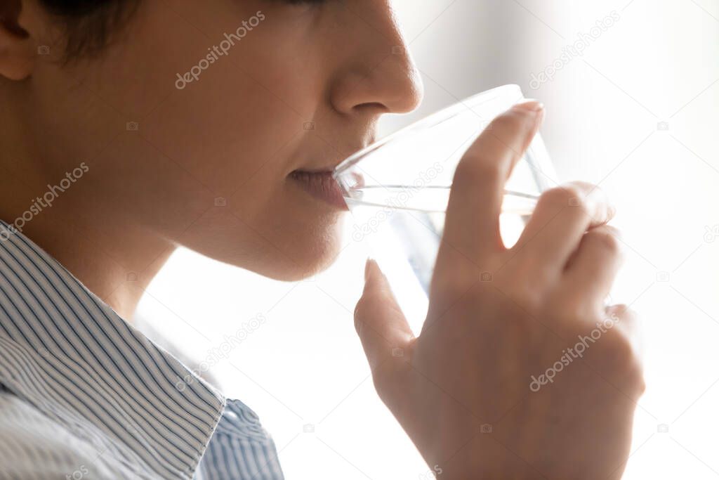 Young mixed race girl taking care of health, preventing dehydration.