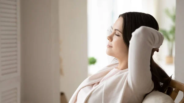 Calm young woman relax in chair taking nap — Stock Photo, Image