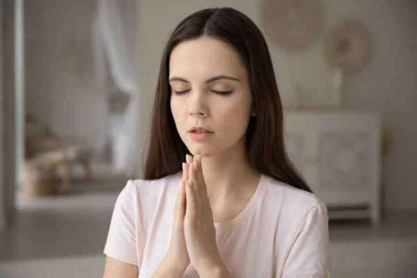 Religious young woman praying to God at home — Stock Photo, Image