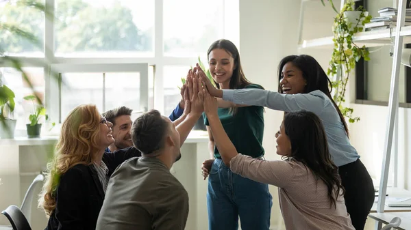 Funny diverse workers with happy female leader giving high five. — Stock Photo, Image