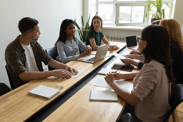 African american mentor businesswoman conducts coaching in boardroom using laptop.