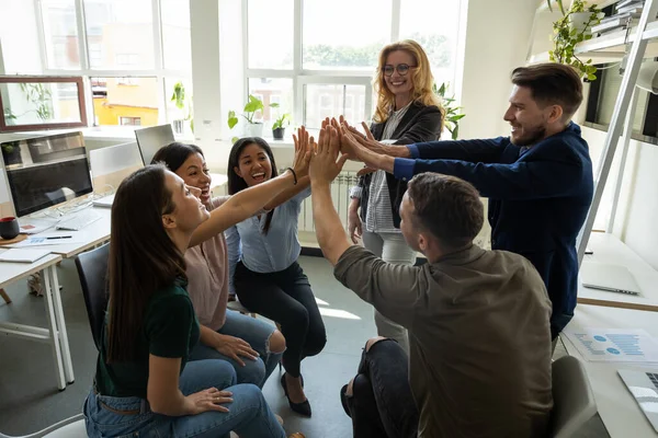 Multiracial employees team with male leader, coach giving high five. — Stock Photo, Image
