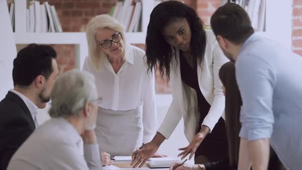 アフリカ系アメリカ人女性チームリーダーが同僚に労働問題を説明. — ストック動画