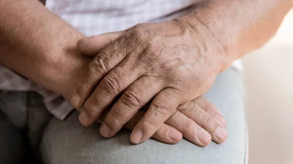 Senior man holding hands feeling lonely in the retirement house — Stock fotografie