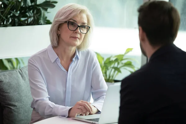 Middle aged hr manager listen male applicant during job interview — Stock Photo, Image