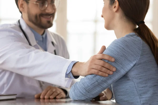 Positive male doctor support female patient at consultation — Stock Photo, Image