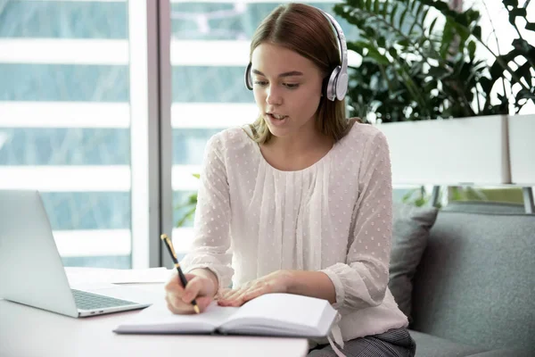 Businesswoman wears headphones involved in business conference with company clients — Stock Photo, Image