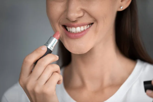 Close up cropped image woman holds lipstick near lips — Stock Photo, Image