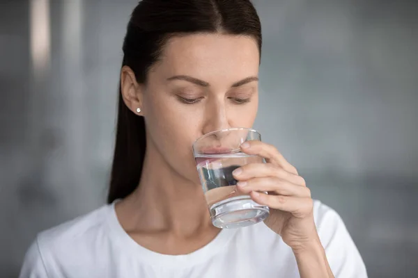 Attractive woman drinking still water closeup portrait — Stock Photo, Image