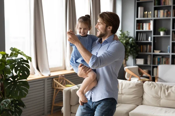 Happy young dad dancing with cute little daughter — Stock Photo, Image