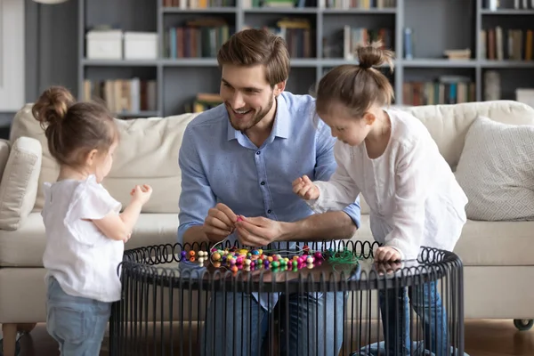 Loving dad engaged in creative activity with daughters — Stock Photo, Image