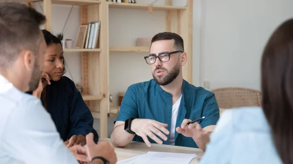 Confident bearded businessman telling diverse employees about project. — Stock Photo, Image