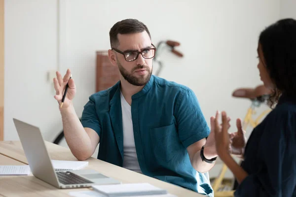 Serious businessman perplexed by female colleague decision in office. — Stock Photo, Image