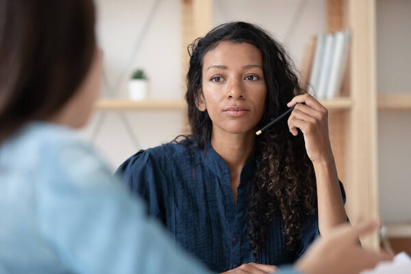 Close up focused african american businesswoman listening new female applicant.