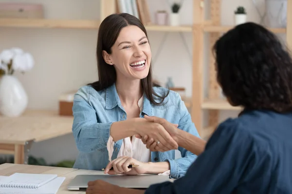 Close up smiling young businesswoman shaking hands with job seeker. — Stock Photo, Image