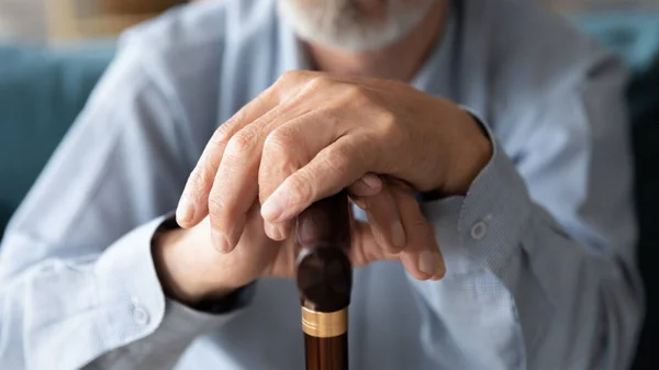 Close up ältere ältere reife Mann lehnt Hände auf Gehstock. — Stockfoto