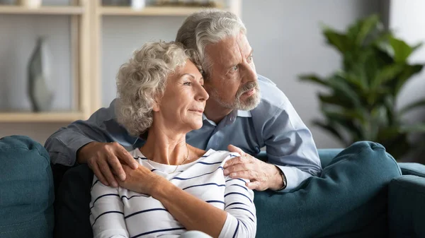 Happy calm senior retired family spouses dreaming of future.