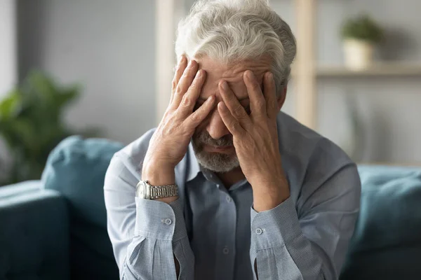 Unhappy middle aged retired grandfather suffering from high blood pressure. — Stock Photo, Image