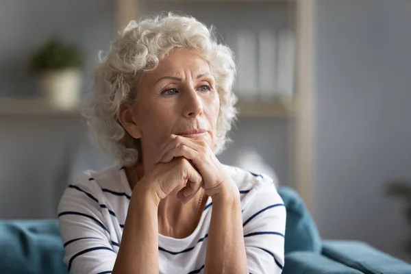 Thoughtful middle aged elder woman put head on hands. — Stock Photo, Image