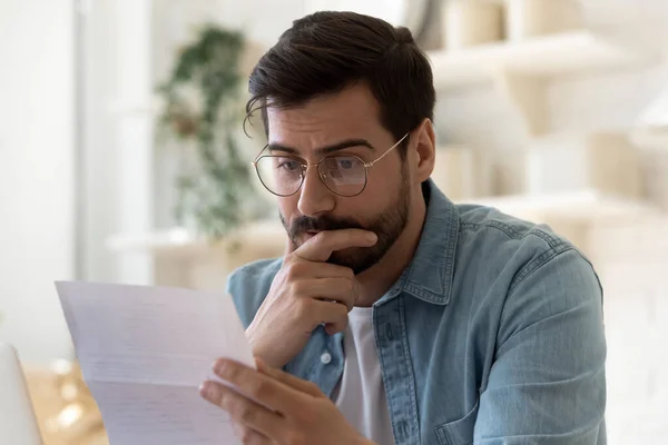 Frustrated man read bad news in paper post letter