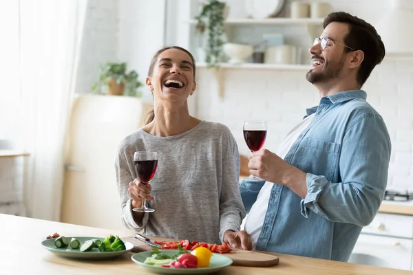 Happy millennial couple have fun celebrating at home kitchen — Stock Photo, Image