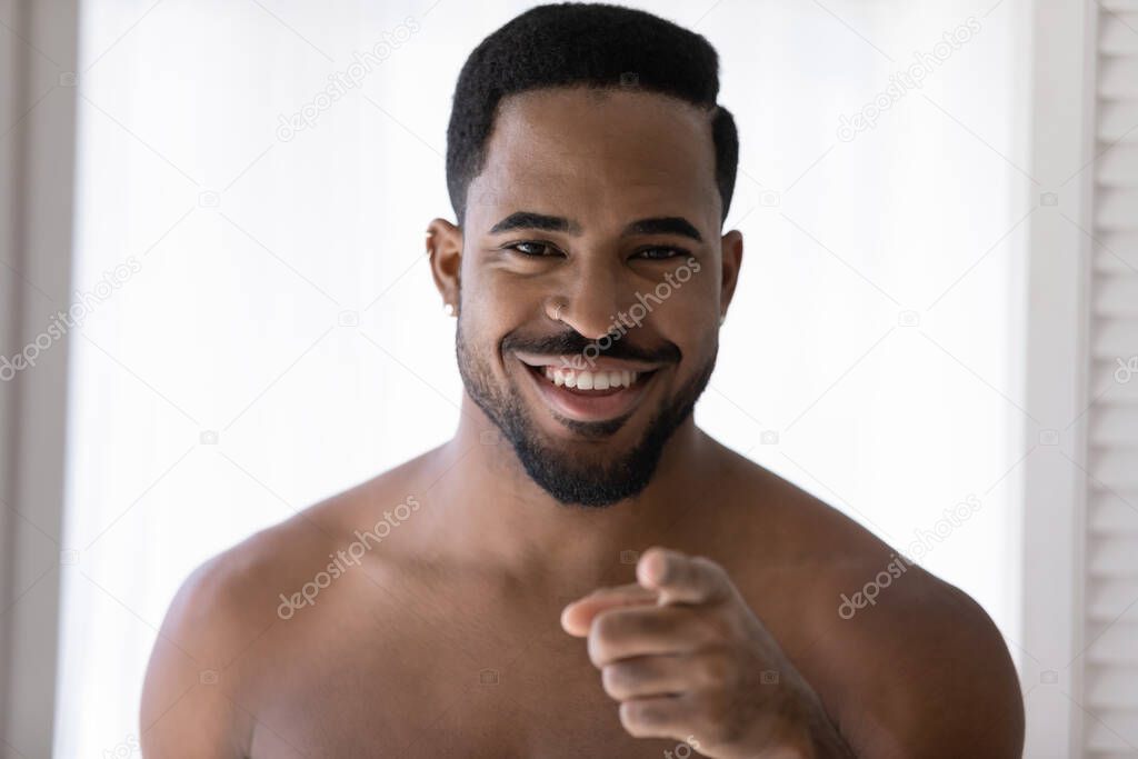 Portrait of smiling african american man posing in bathroom