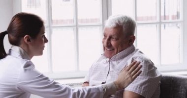 Genç kadın pratisyen doktor yaşlı bir hastanın omzuna dokundu..