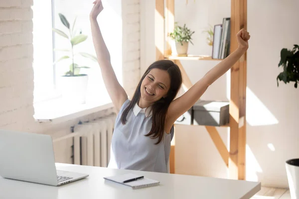 Happy female employee stretch exercise at workplace — Stock Photo, Image