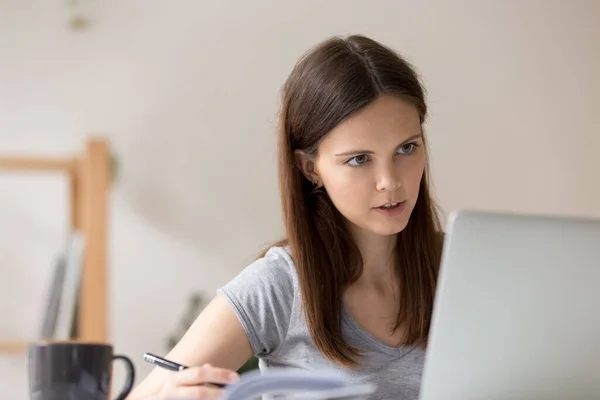 Concentrated millennial girl study online on laptop — Stock Photo, Image