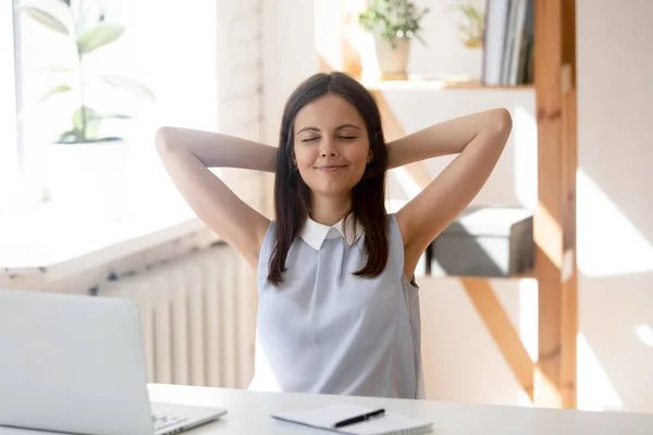 Calm female employee relax in chair at workplace — Stock Photo, Image