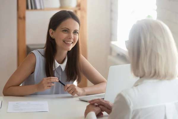 Young female employer talk with applicant at interview in office — Stock Photo, Image