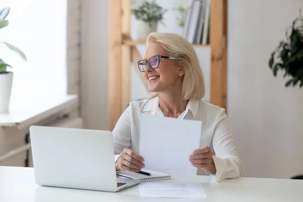 Smiling senior woman look in distance thinking — Stock Photo, Image