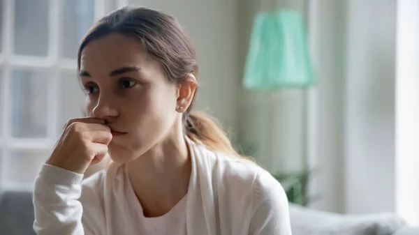 Upset young woman look in distance pondering — Stock Photo, Image