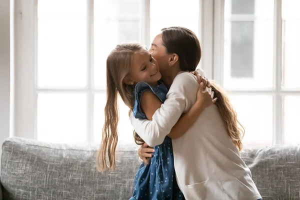 Happy mom and little daughter hugging at home — Stock Photo, Image