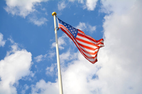 American flag in the blue sky