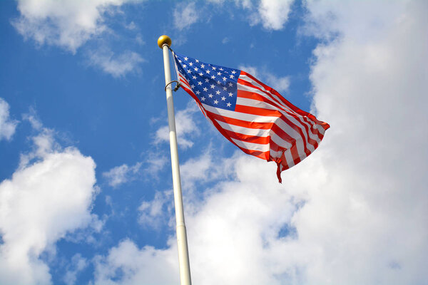 American flag in the blue sky